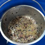 Crushed wine grapes in a bucket.